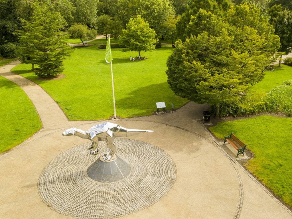 aerial view of close park frontage and park green with dinosaur sculpture