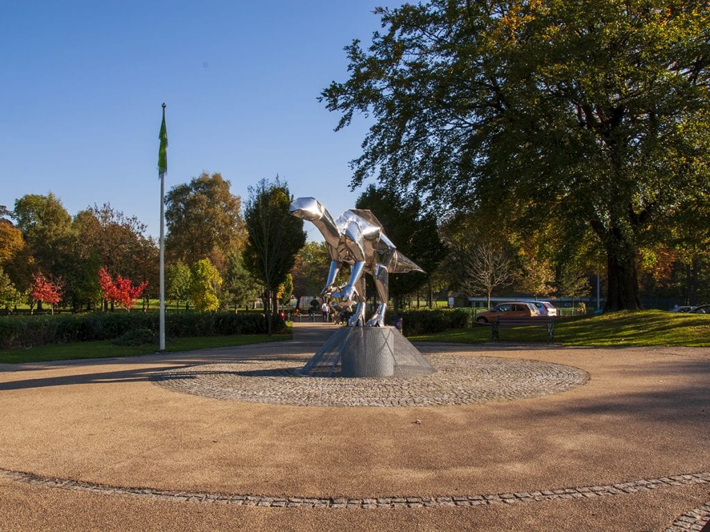 View of Close Park central arrival space and Mark Jalland sculpture with views down axis to play areas and pitches