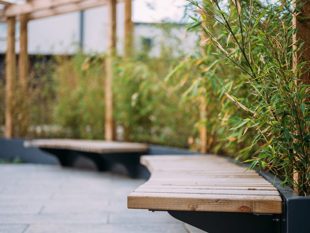 cantilever seat slats on raised planter with bamboo screening