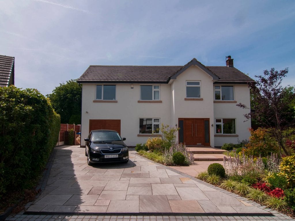 View of front garden designed by Natural Dimensions with driveway and steps rising to front door including Carex Evergold, Acer, verbena boniarensis , Heuchera, stachys and buxus balls