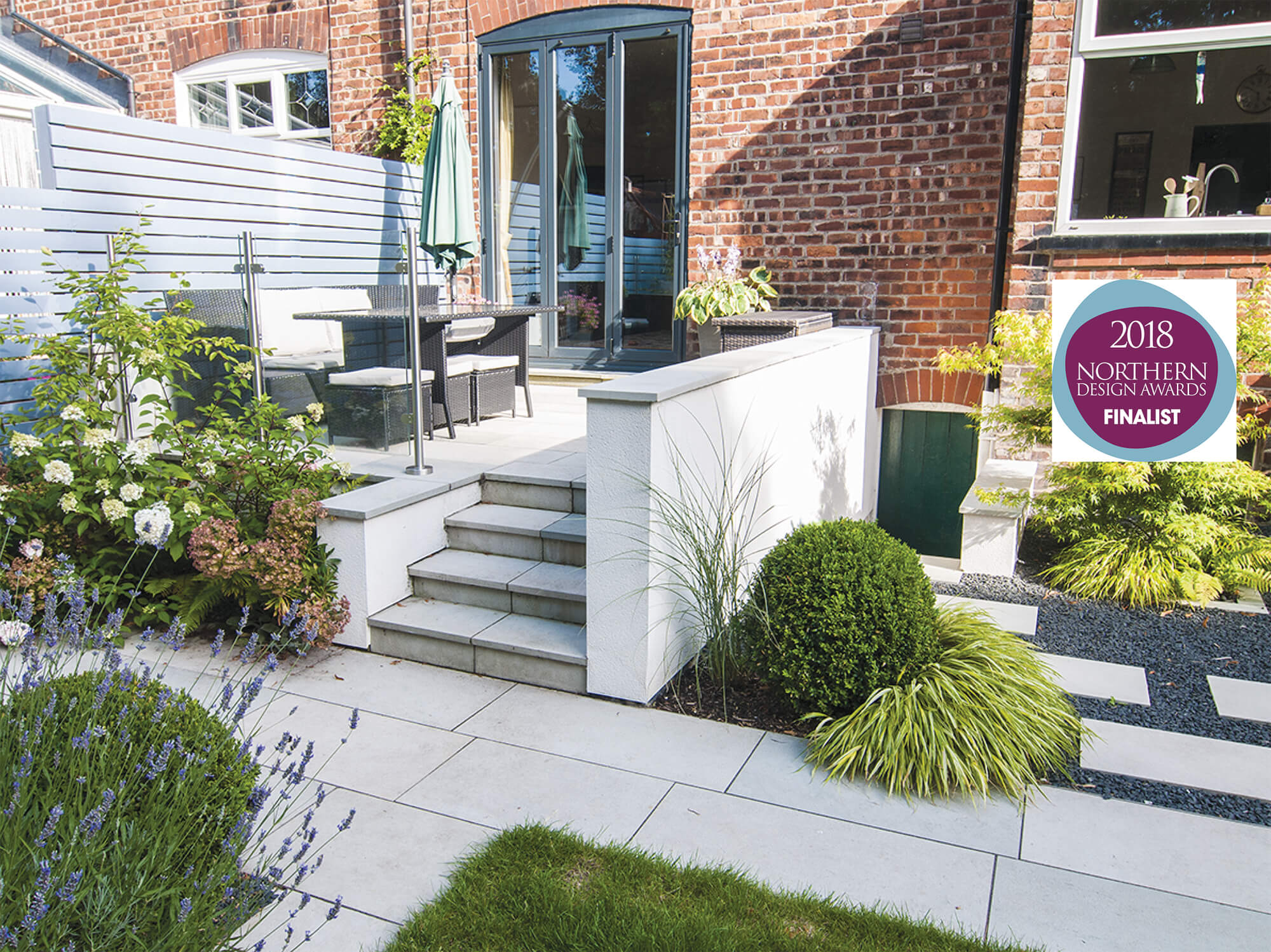 Raised patio with box balls and hydrangea, Japanese stepping stones and basalt gravel Northern Design Awards finalist