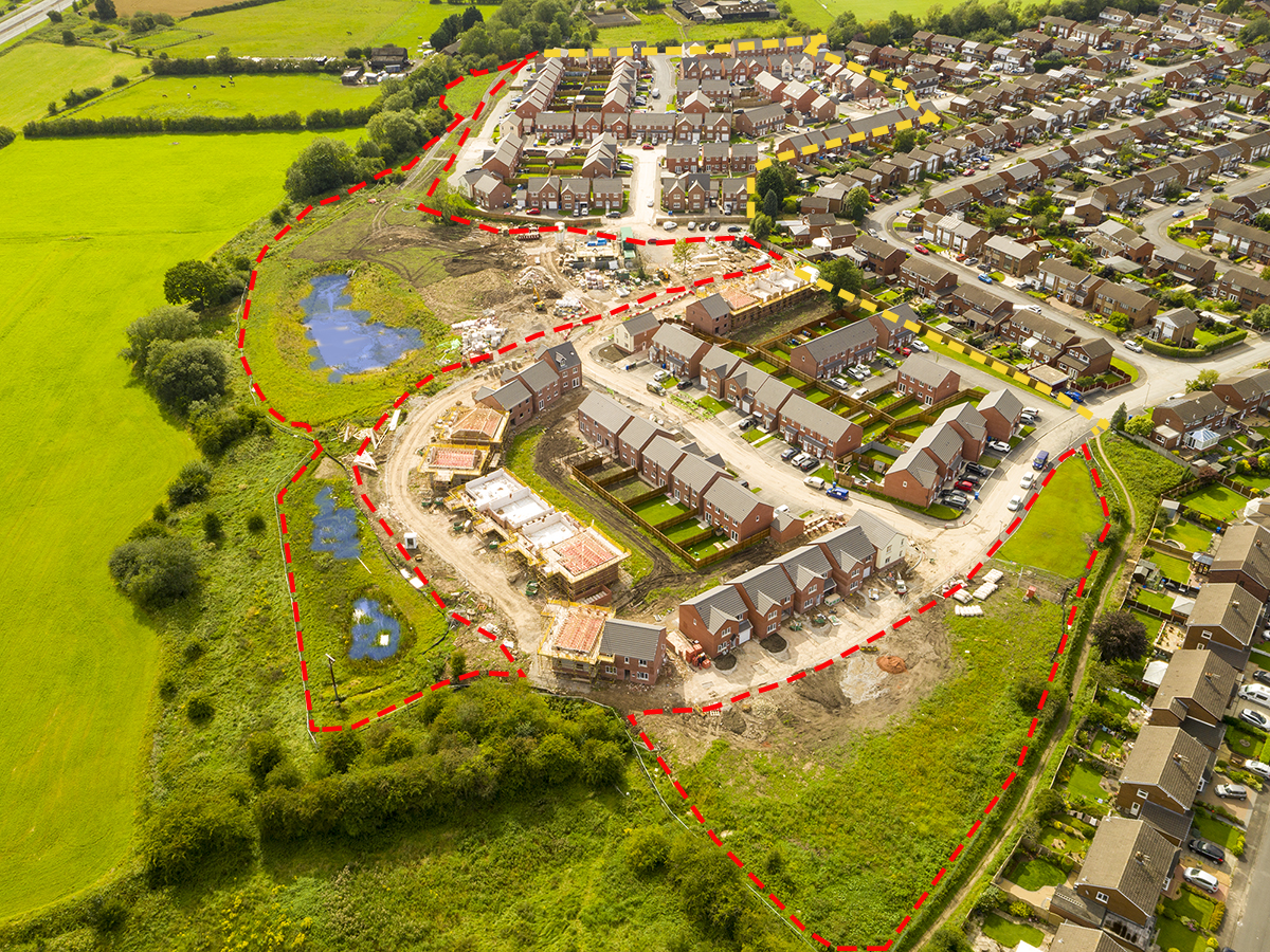 aerial view of The Pastures housing construction development with park and ponds in progress showing park and habitat areas and ponds areas outlined in red