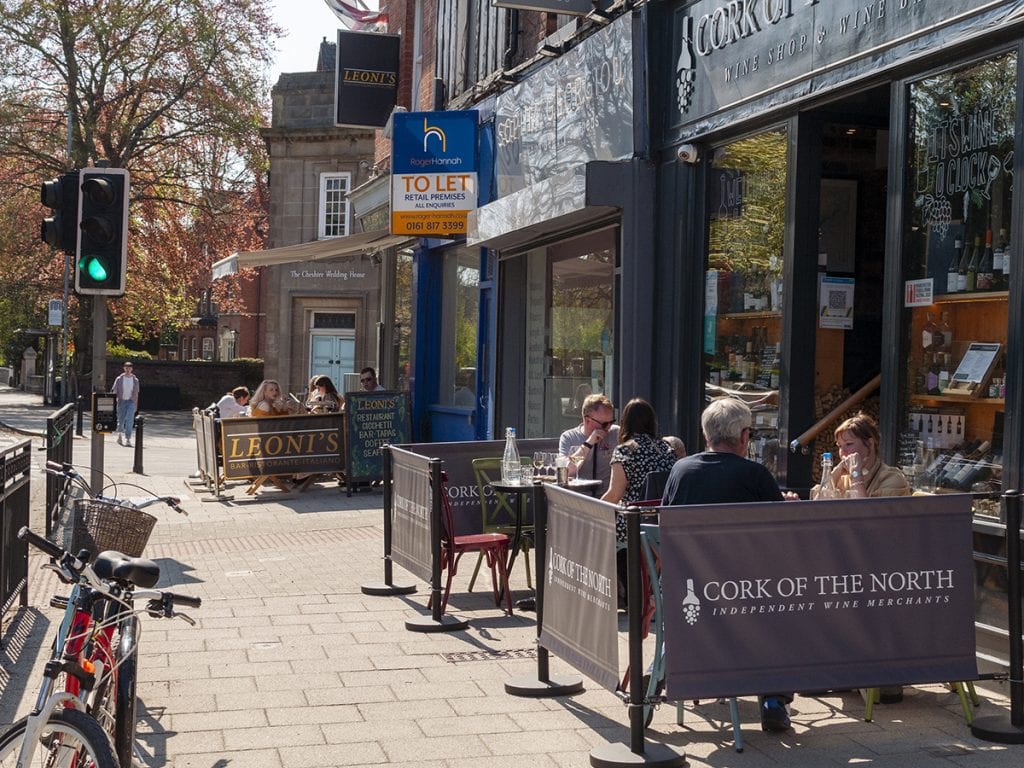 people drinking at Leoni's and Cork of the North outdoor seating street on Heaton Moor Road post lockdown