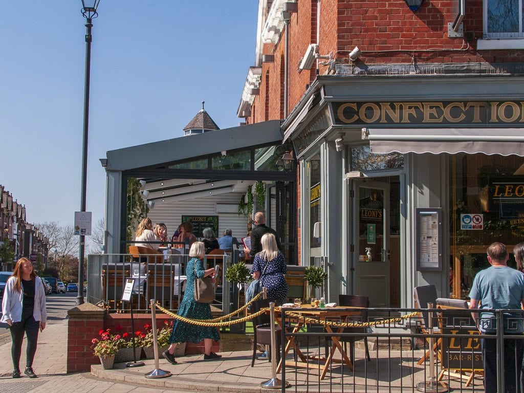 streetlife people drinking at Leoni's on outdoor seating street on Heaton Moor Road post lockdown