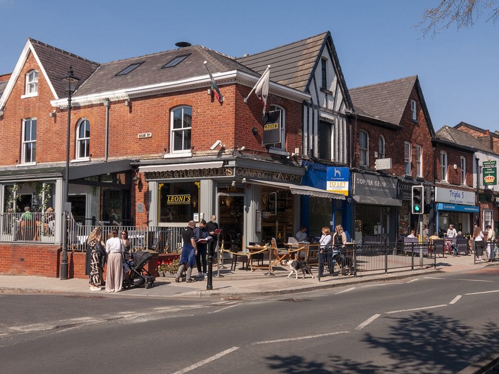 people drinking at Leoni's and Cork of the North outdoor seating street on Heaton Moor Road post lockdown